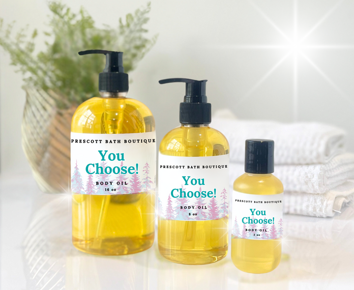 Three bottles of Prescotty Bath Boutique body oil on a white surface with a blurred background.